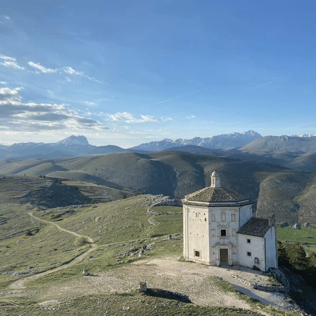 A viewpoint of A chapel overlooking the Abruzzo mountains in Italy with The Slow Cyclist.