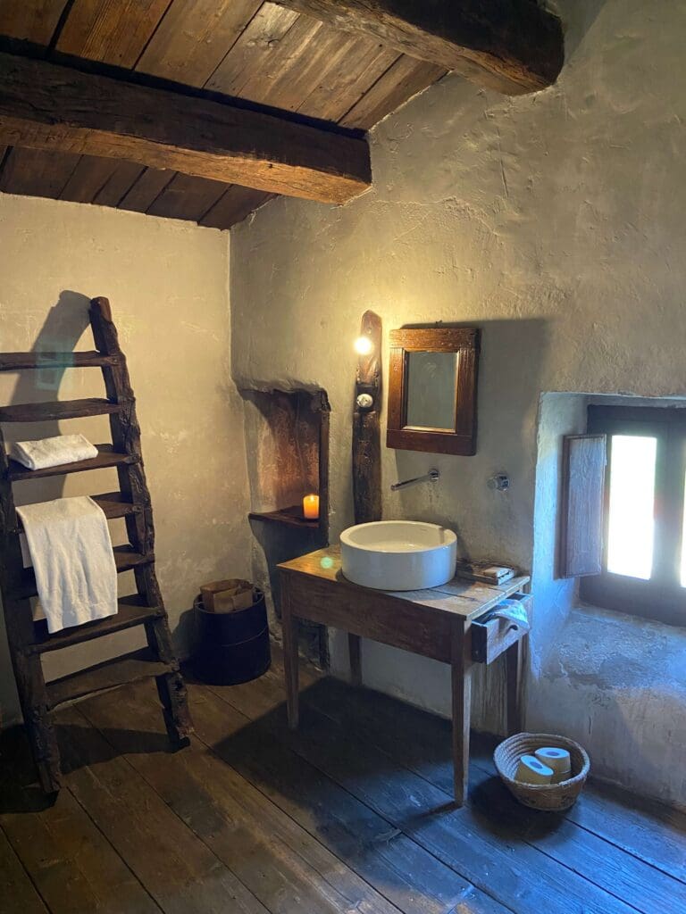 A Slow Cyclist guest house bathroom, with basin and mirror in Abruzzo, Italy.