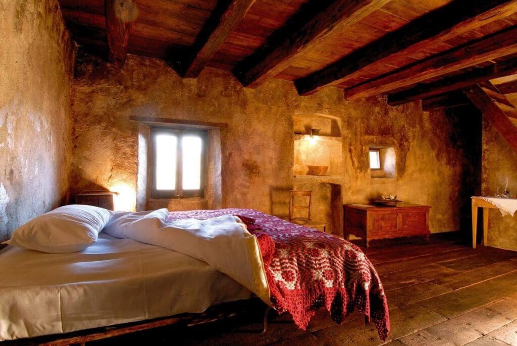 A Slow Cyclist traditional guesthouse with traditional stone walls and wooden beams, in Abruzzo, Italy.