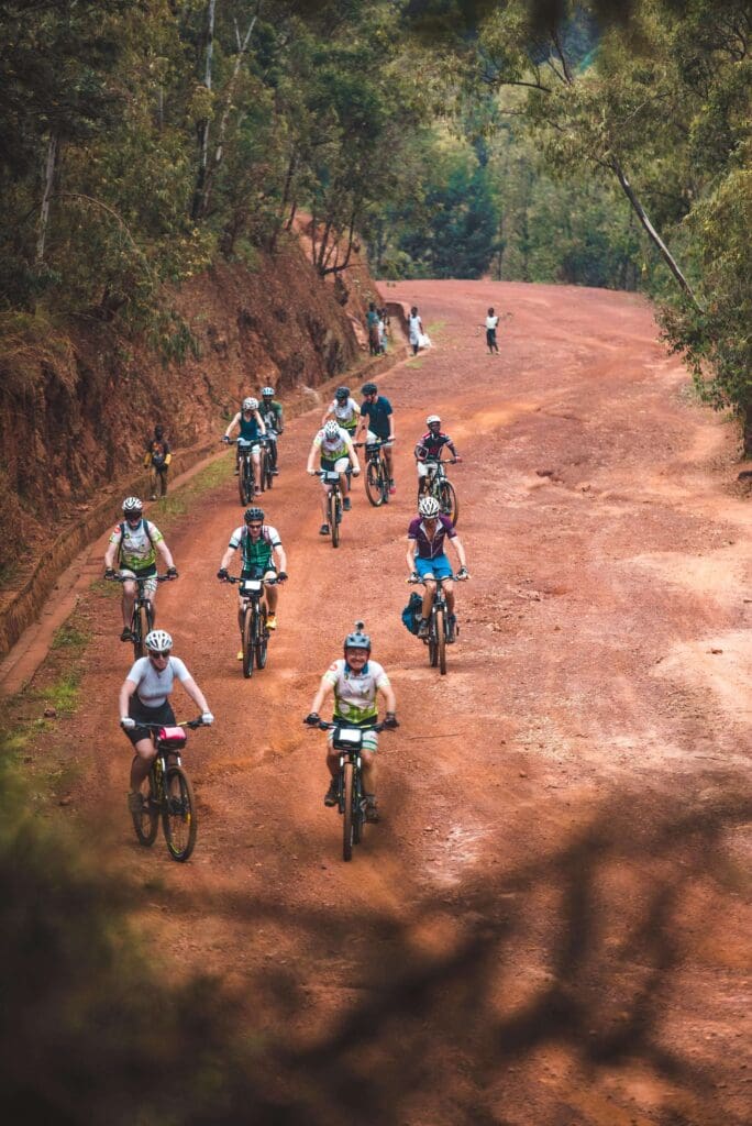 A group of Slow Cyclists on a rough dirt track road in rural Rwanda.