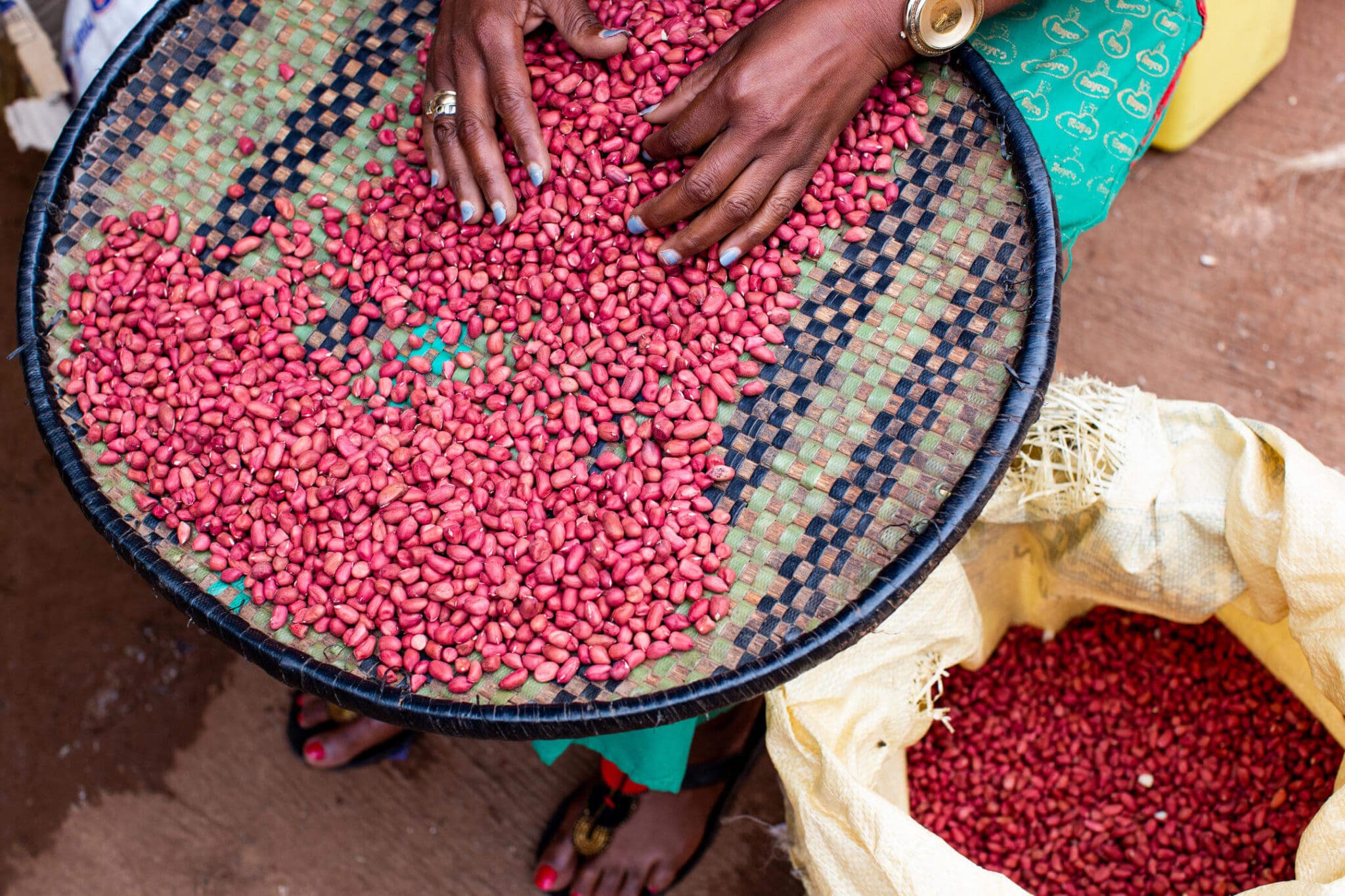 A Rwandan lady selling her seeds at a local market.