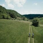 Cyclists in the meadows of Transylvania on a Slow Cyclist journey
