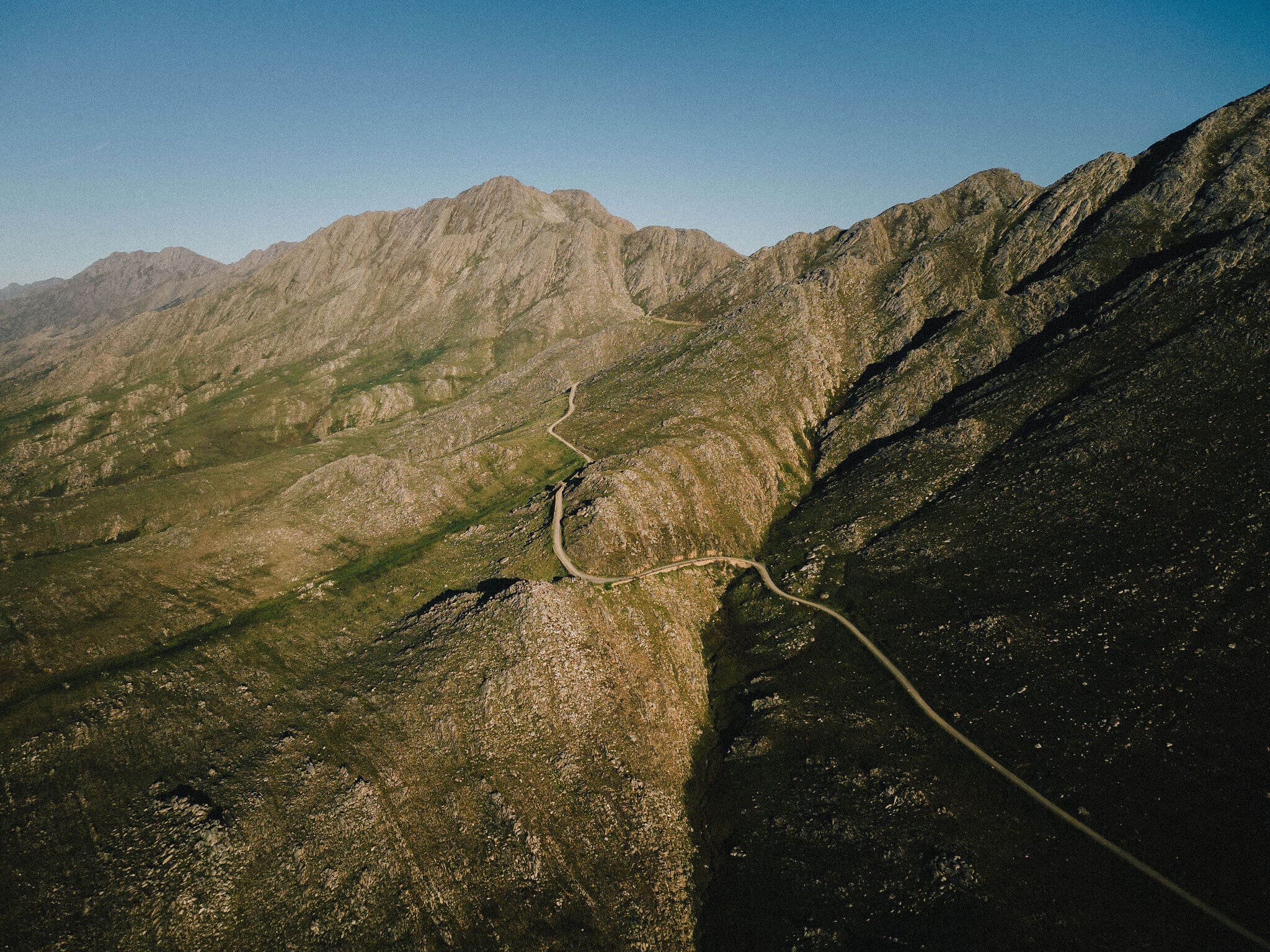 A winding road through the Swartberg Mountains in South Africa's Karoo, visited on a Slow Cyclist journey