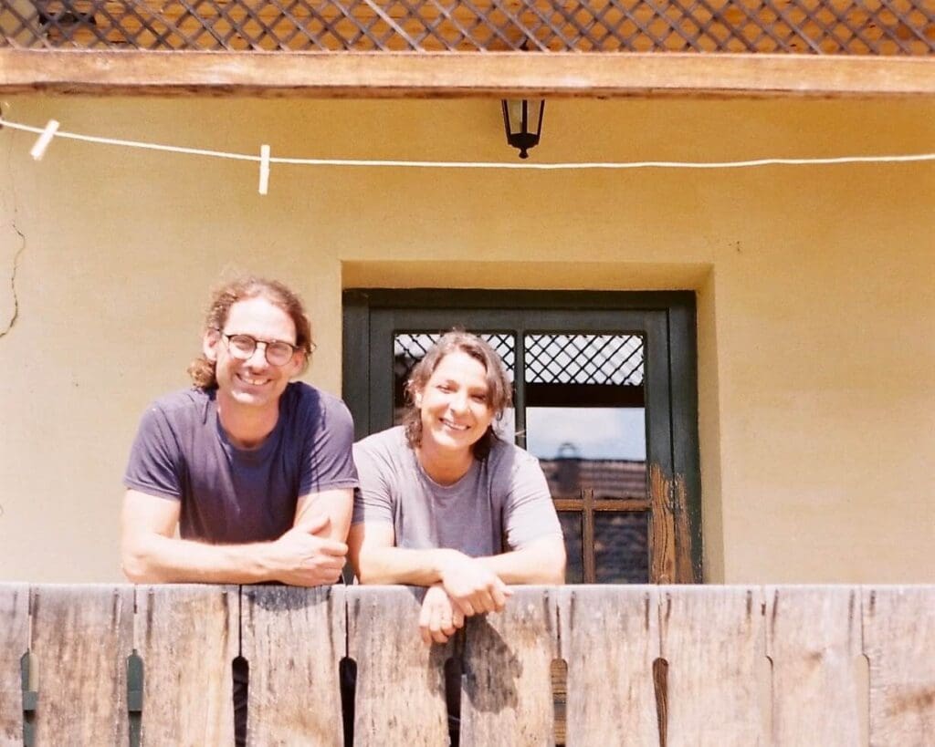 Anca and Charlie captured on a film camera outside their Transylvanian home, where they cook lunch for Slow Cyclist guests.