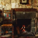 A fireplace in a traditional stone guest house for Slow Cyclists in Zagori, Greece.