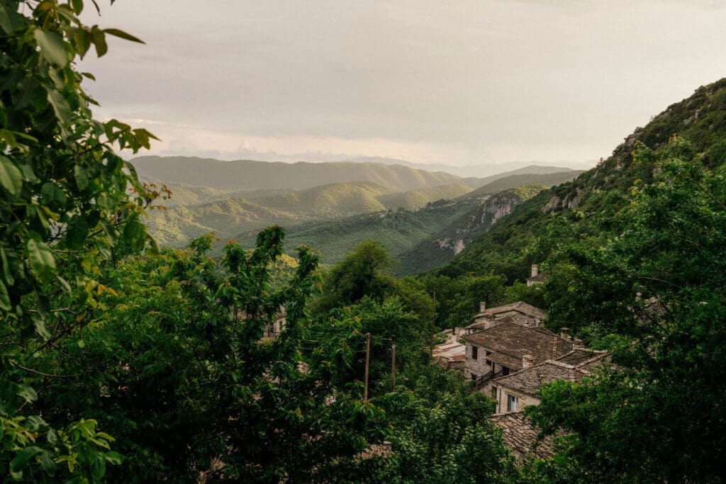 Views over traditional stone houses and mountains in Zagori, Greece, seen on a journey with The Slow Cyclist.
