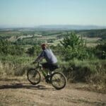 A Slow Cyclist riding through hills in Portugal's Douro region.