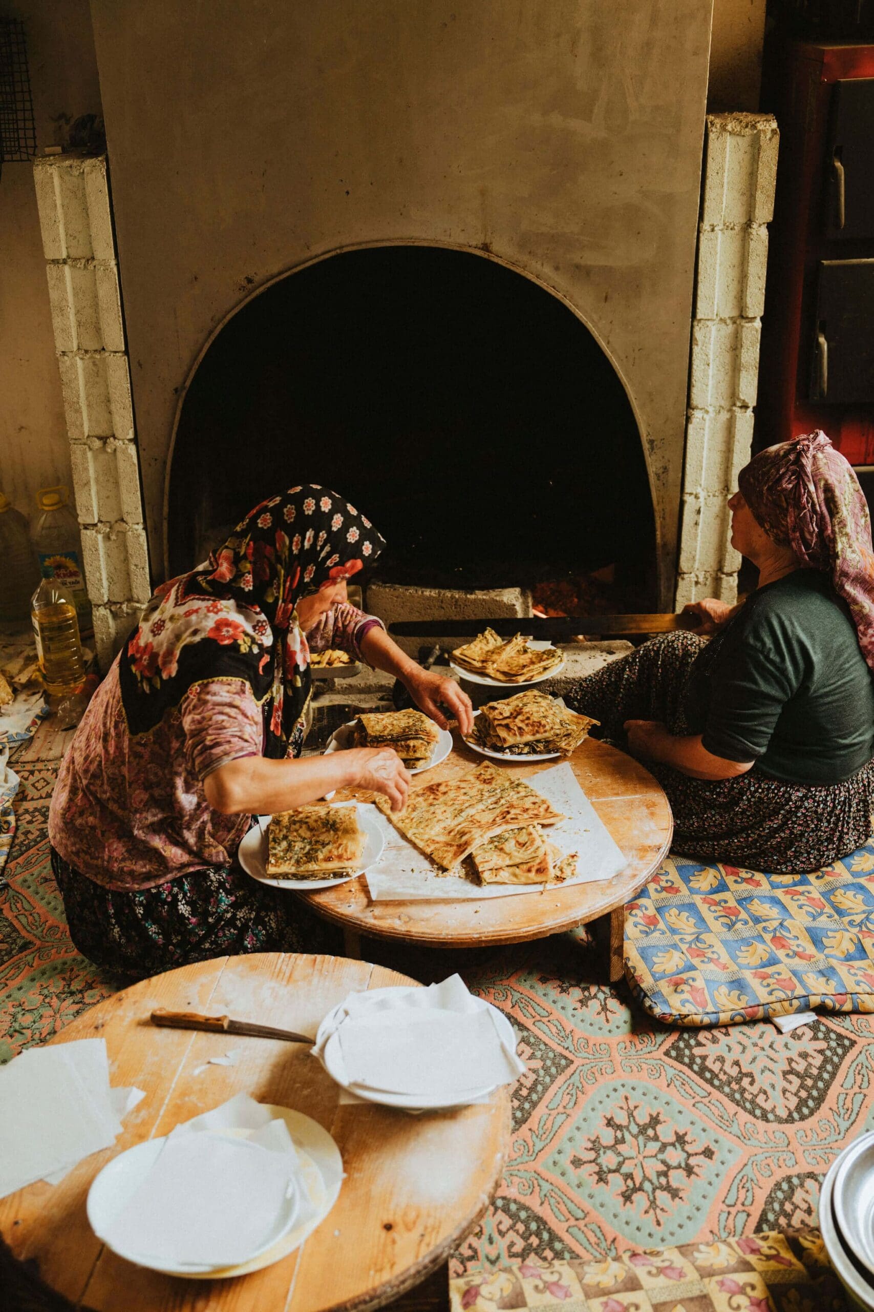 Two local women cooking Gozleme for Slow Cyclists in Turkey's Taurus Mountains.