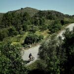 A Slow Cyclist riding through trees and mountains in the Douro region, Portugal