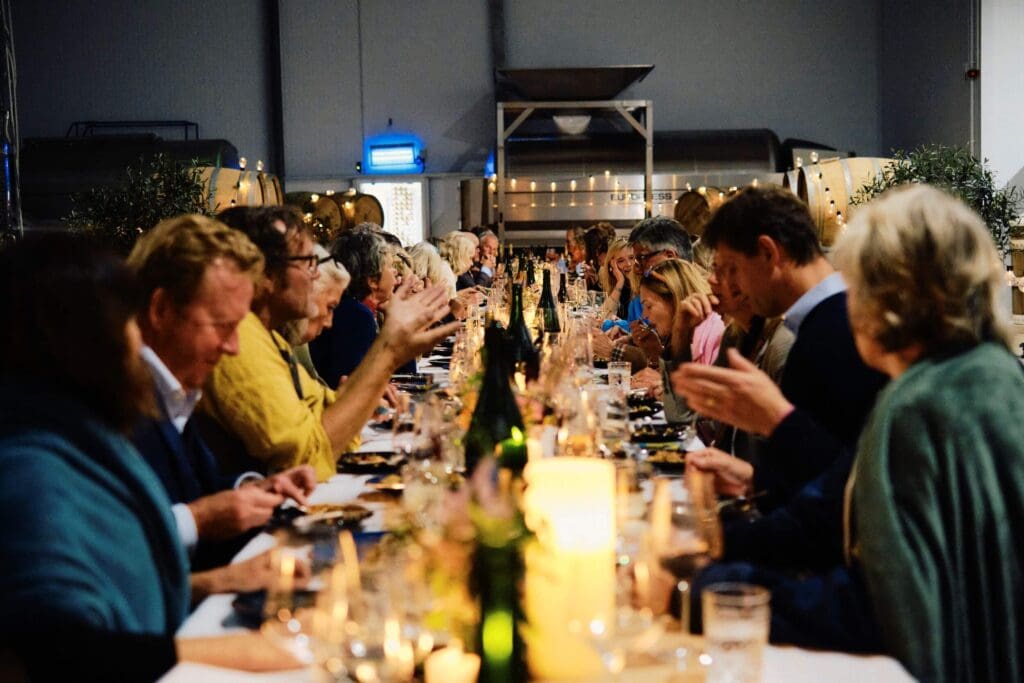 Guests sitting in the winery at The Grange for The Slow Table